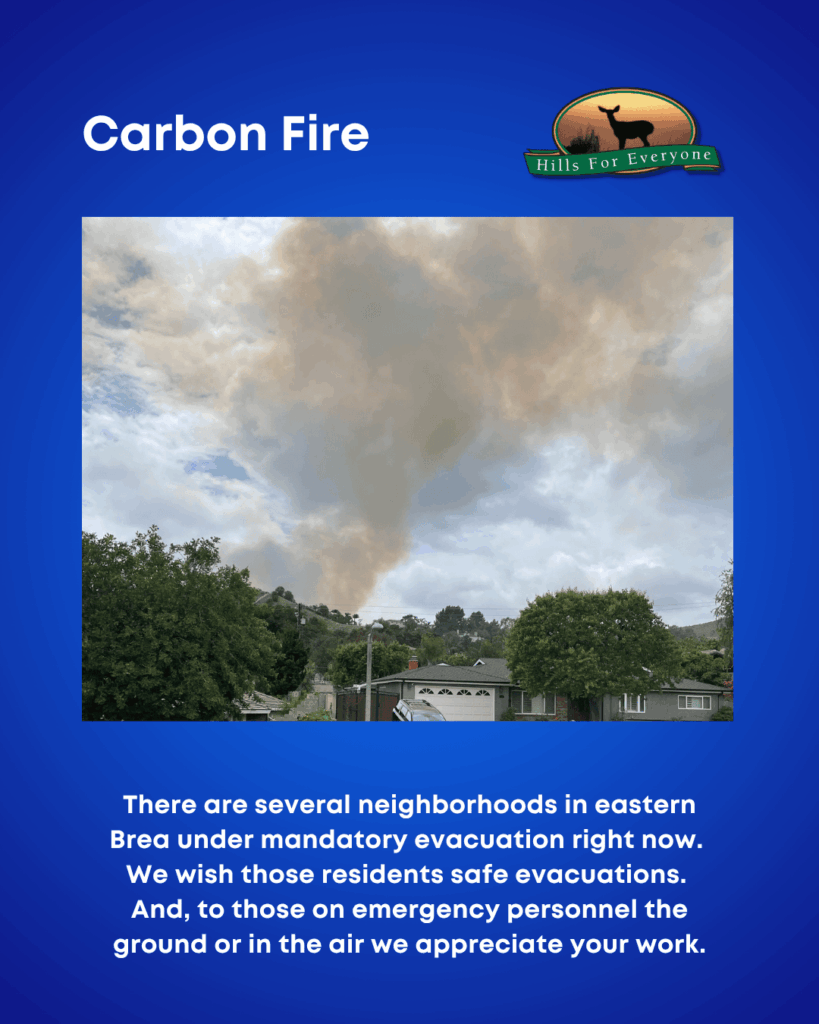 Against a blue background, the HFE logo is upper right, and the title: Carbon Fire in the upper left. There is a photo of a fire in the distance. The text reads: There are several neighborhoods in eastern Brea under mandatory evacuation right now. We wish those residents safe evacuations. And, to those on emergency personnel the ground or in the air we appreciate your work.
